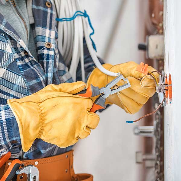 Ampere Electric electrician wiring an outlet during residential electrical work in San Diego